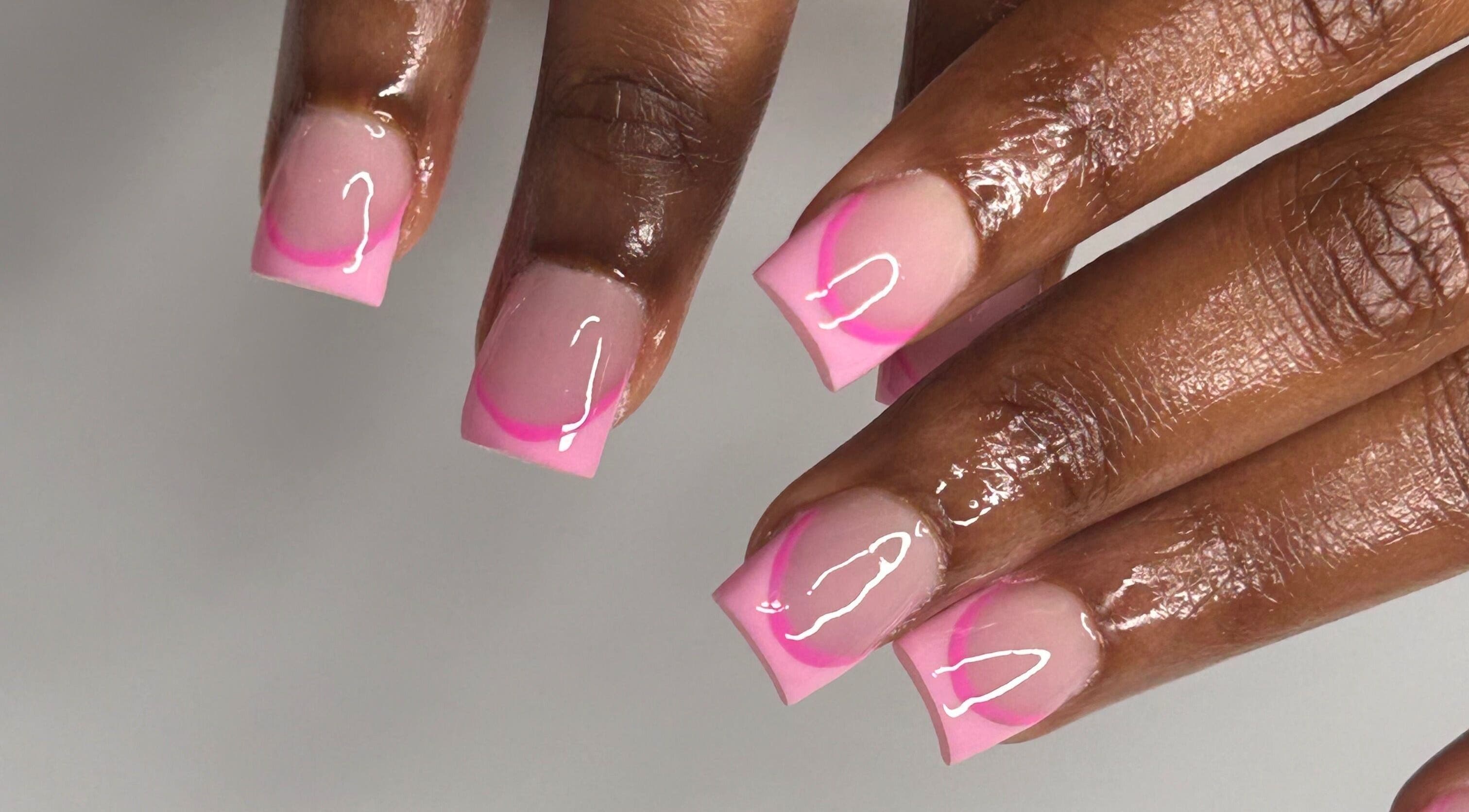 Pink French tips manicure at Nailsbylamie, Luton, England, GB, showcasing gloss and precision.