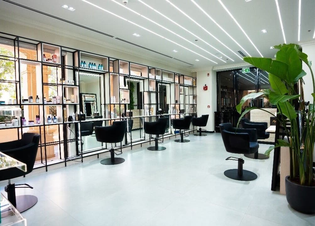 Modern interior of Mike's Beauty Lounge in أبو ظبي, AE with sleek styling chairs and products on display.