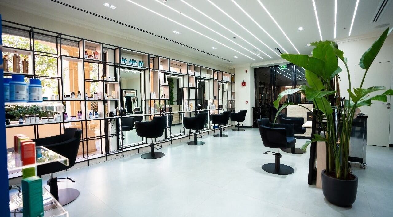Modern interior of Mike's Beauty Lounge in أبو ظبي, AE with sleek styling chairs and products on display.