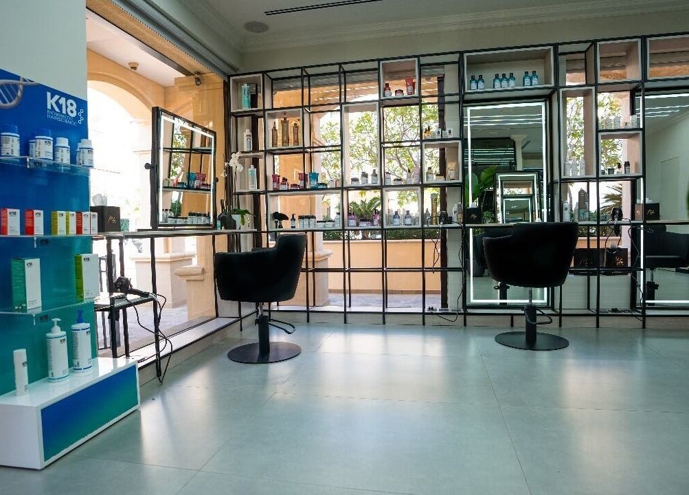Chic interior of Mike's Beauty Lounge, Abu Dhabi, showcasing stylish seating and product displays.