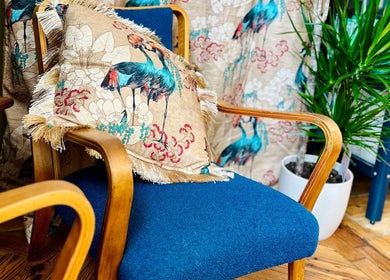 Stylish wooden chair with a vibrant pillow at Matthew Morris with Peluka Salon, Southend on Sea, England, GB.