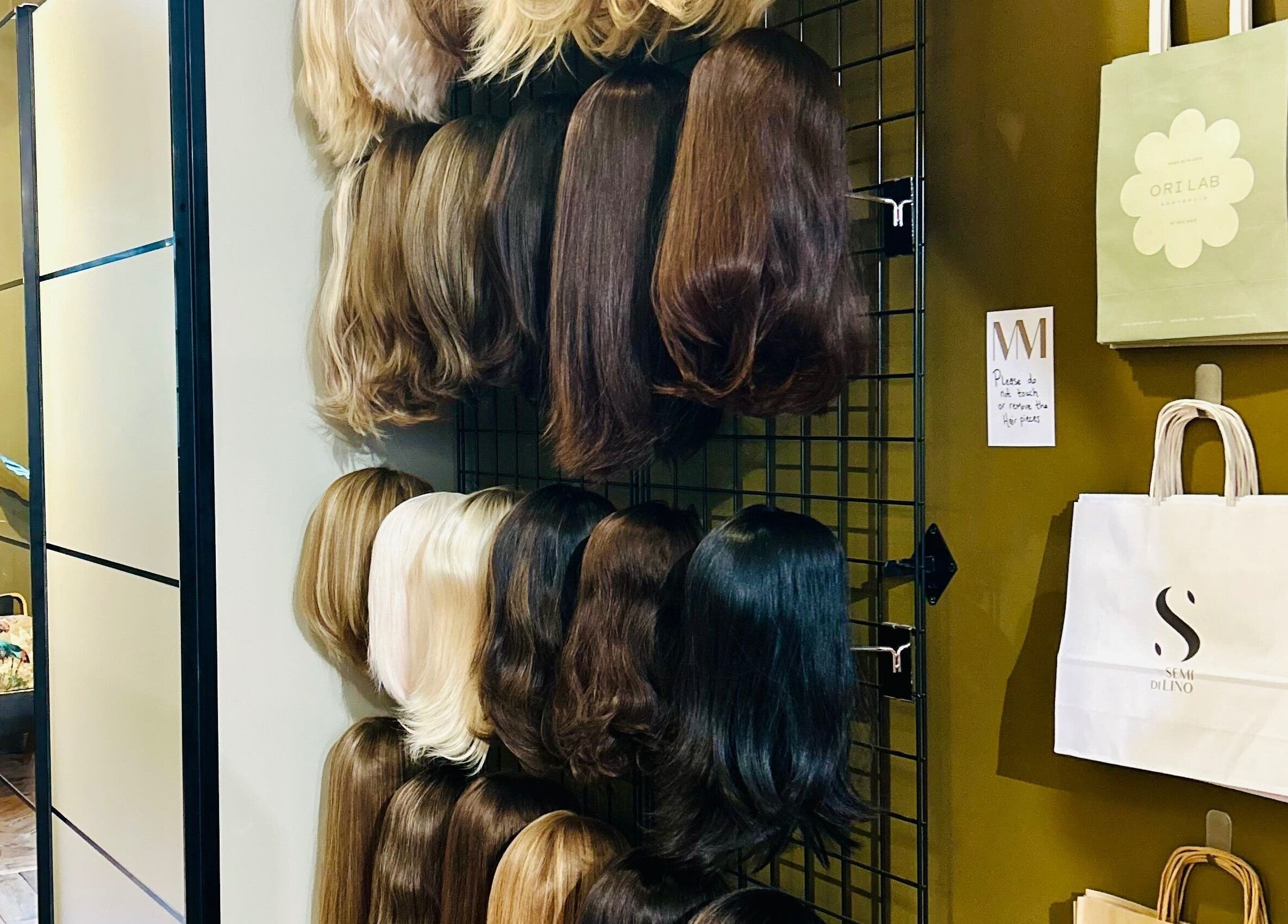 Wigs displayed on a wall at Matthew Morris with Peluka Salon, Southend on Sea, England, GB.
