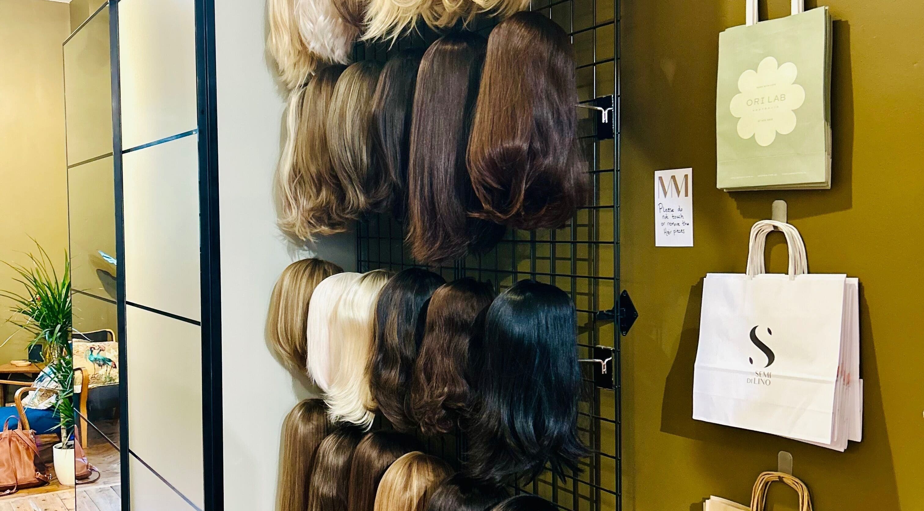 Wigs displayed on a wall at Matthew Morris with Peluka Salon, Southend on Sea, England, GB.