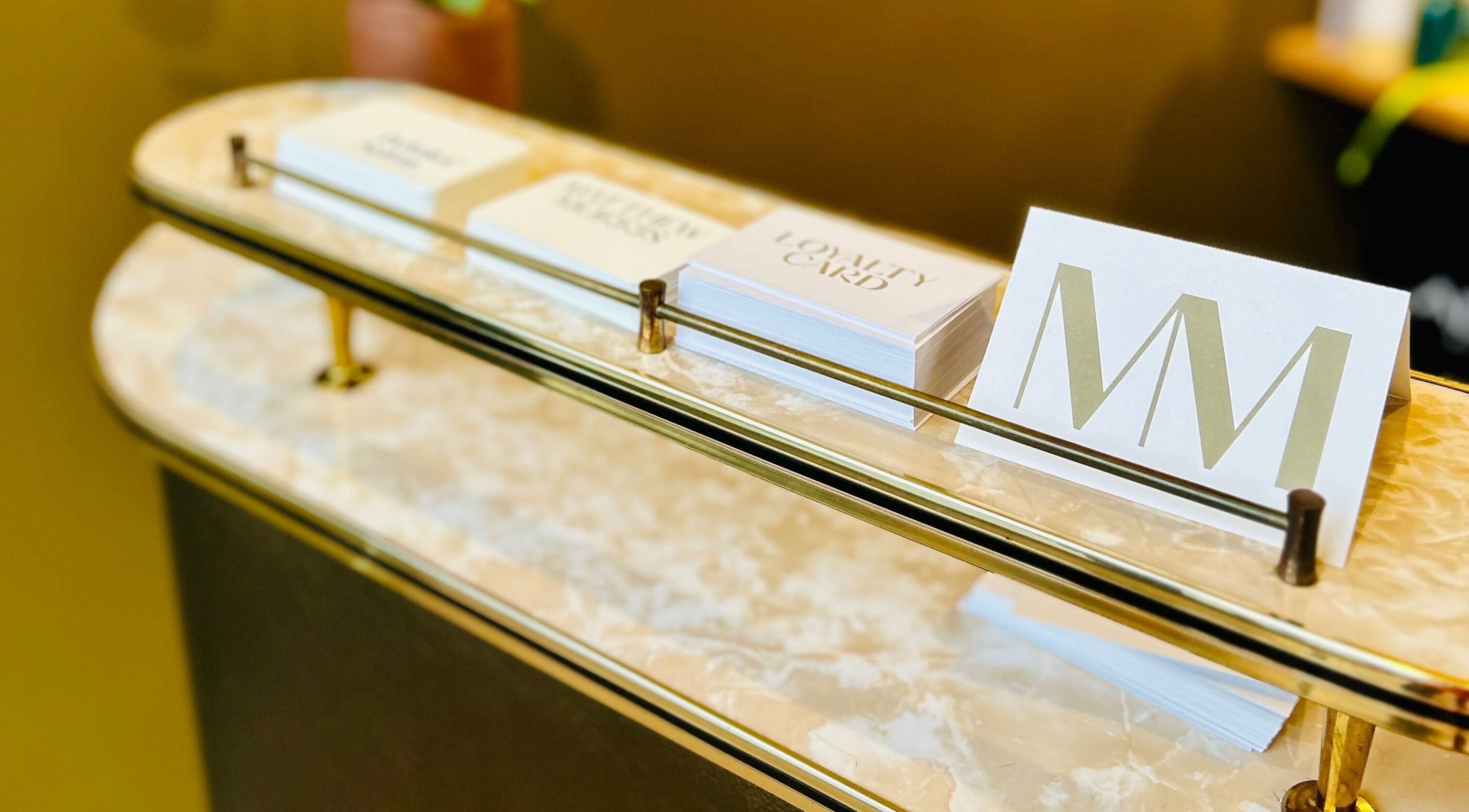 Reception desk at Matthew Morris with Peluka Salon, Southend on Sea, England, GB, displaying loyalty cards.