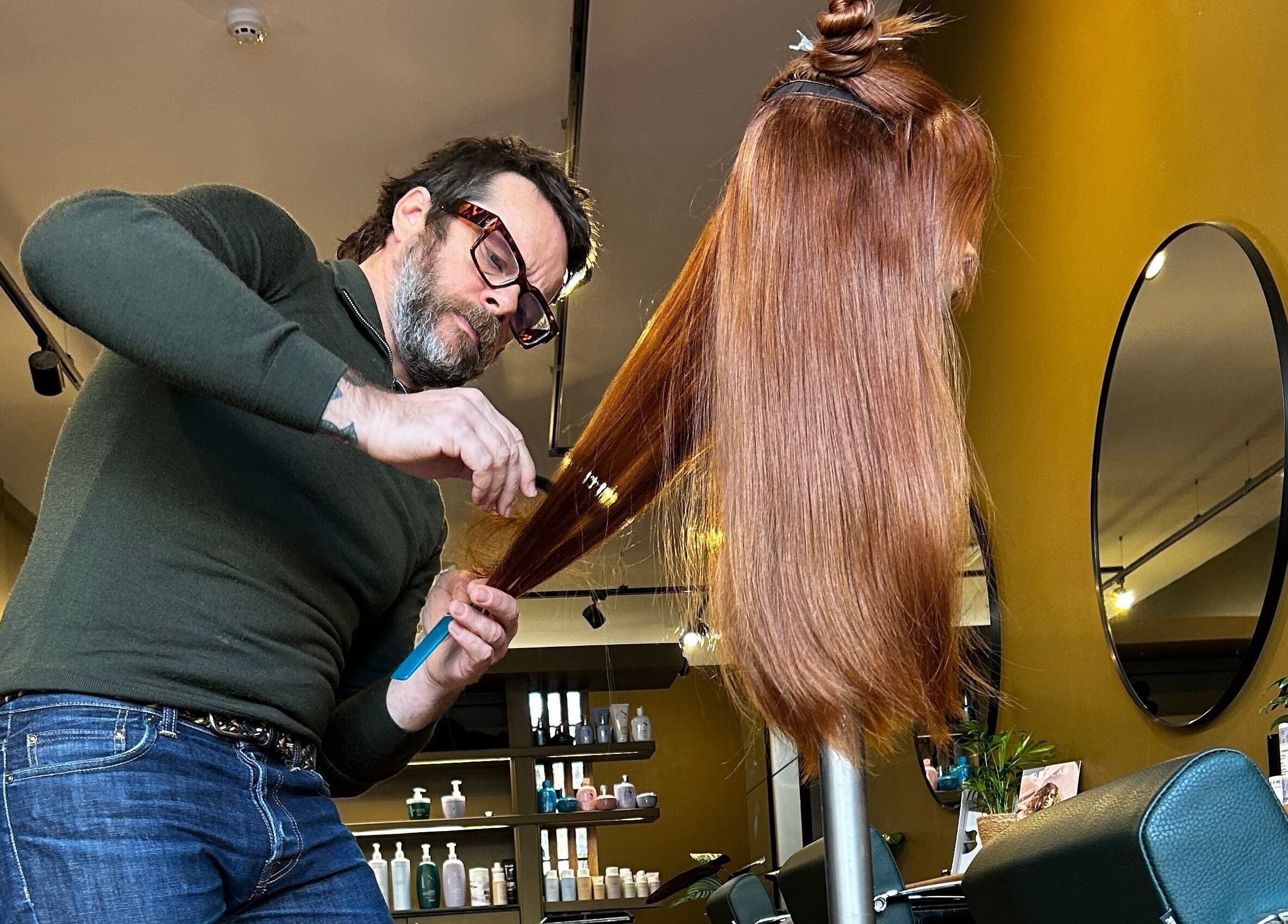 Stylist at Matthew Morris with Peluka Salon in Southend on Sea, England, crafting a sleek hairstyle.