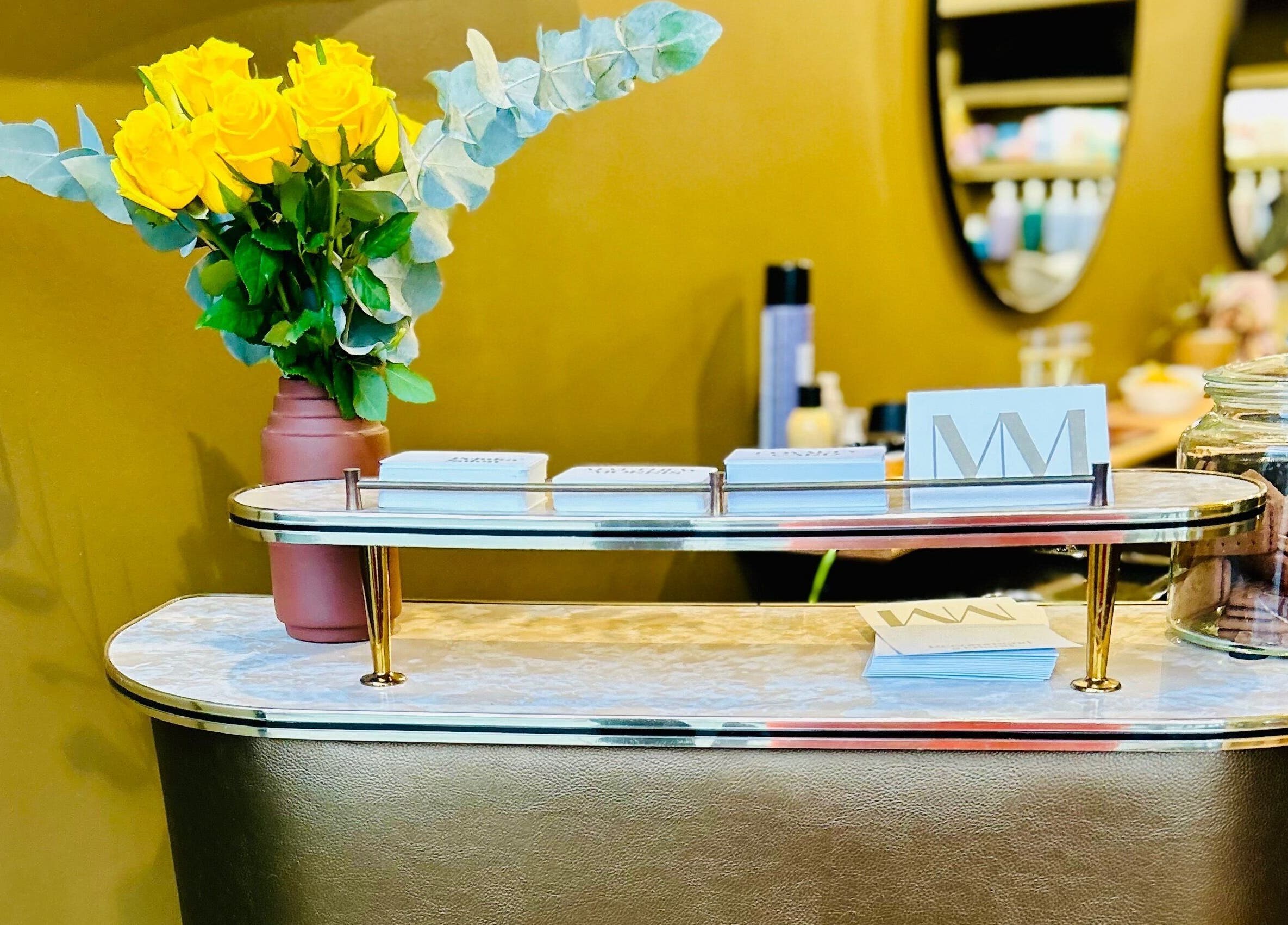 Reception desk with flowers and brochures at Matthew Morris with Peluka Salon, Southend on Sea, England, GB.