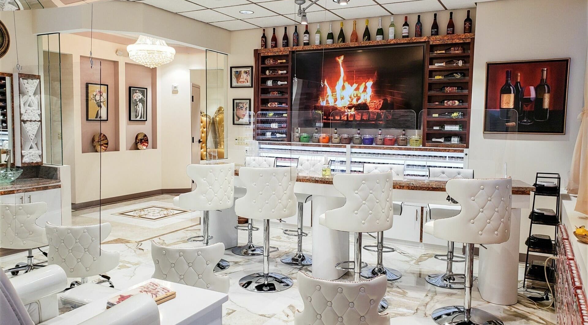 Elegant lounge at Lip Lash Organic Spa in Ashburn, Virginia, US with chic white chairs and plush decor.