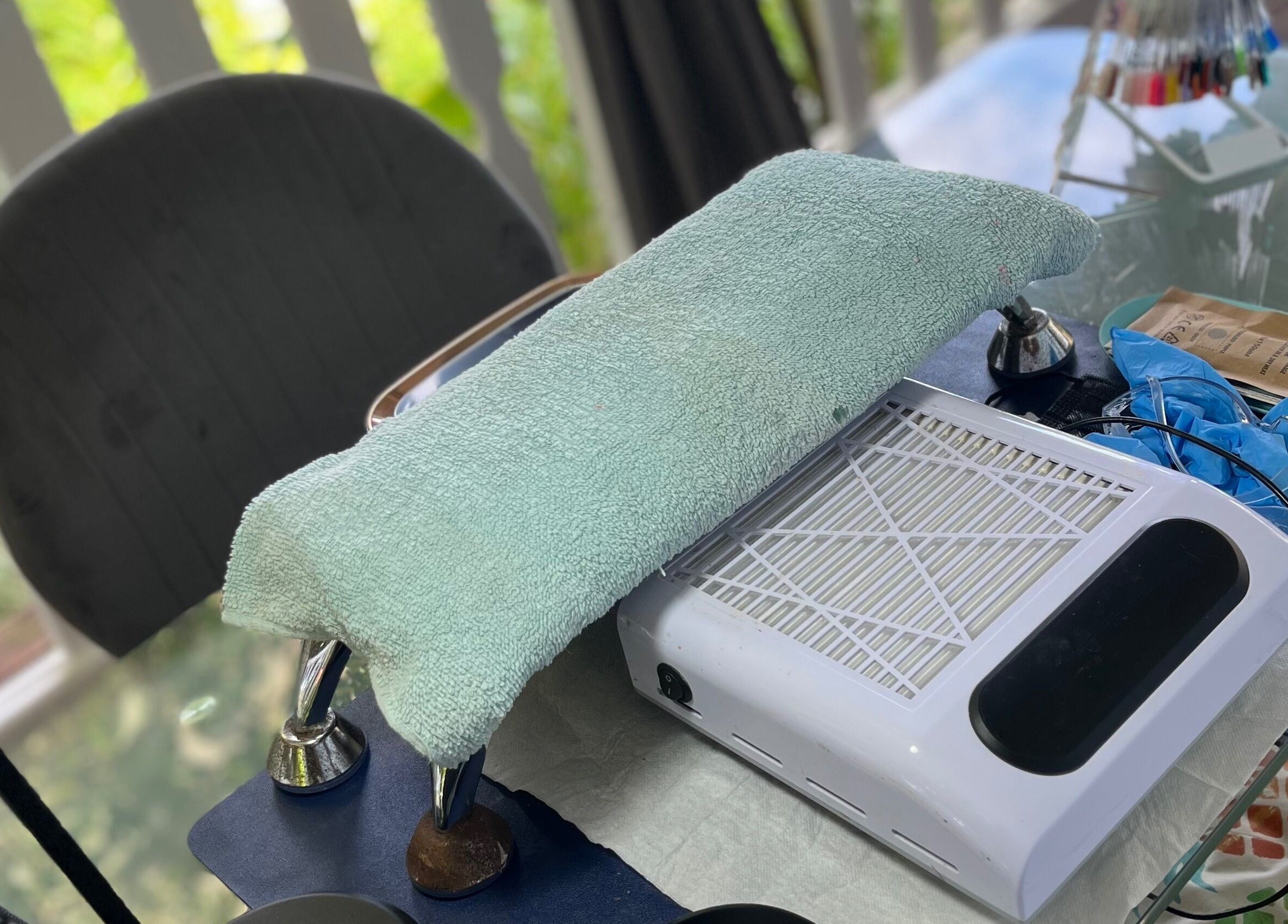 Station de manucure chez Beauty’Nails by Stella à Deshaies, Basse-terre, GP avec coussin vert et équipement.