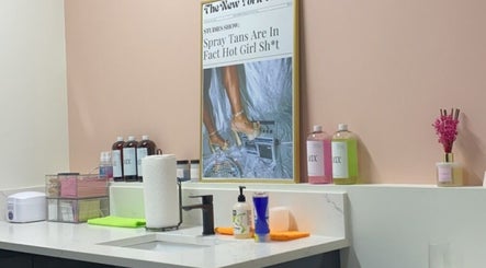 Spray tan setup at Rare Hearts Artistry Spray Tans in Portland, Oregon, US with elegant decor and products.