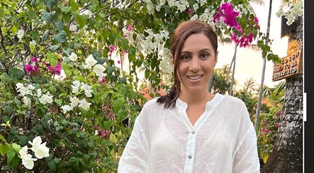 Visitor enjoying lush garden at Healthy Skin Lab, Trinity Beach, Queensland, AU.