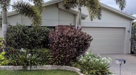 Front view of Healthy Skin Lab at Trinity Beach, Queensland, AU, showcasing lush greenery and a modern facade.
