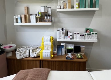Healthy Skin Lab in Trinity Beach, Queensland displays luxury skincare products on white shelves.
