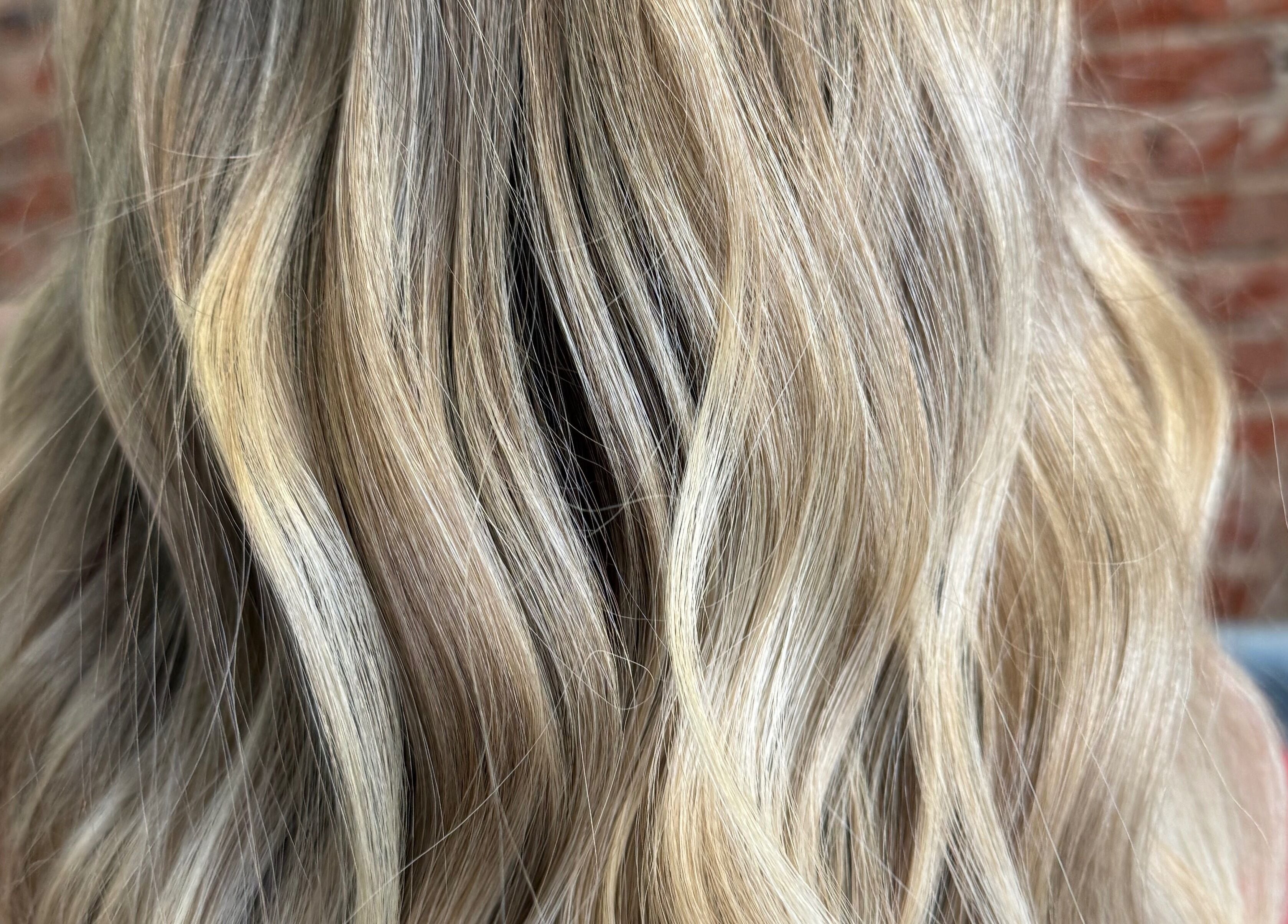 Elegant blonde waves styled at Emmah at Transcendence Salon & Spa in Columbus, Nebraska, US.