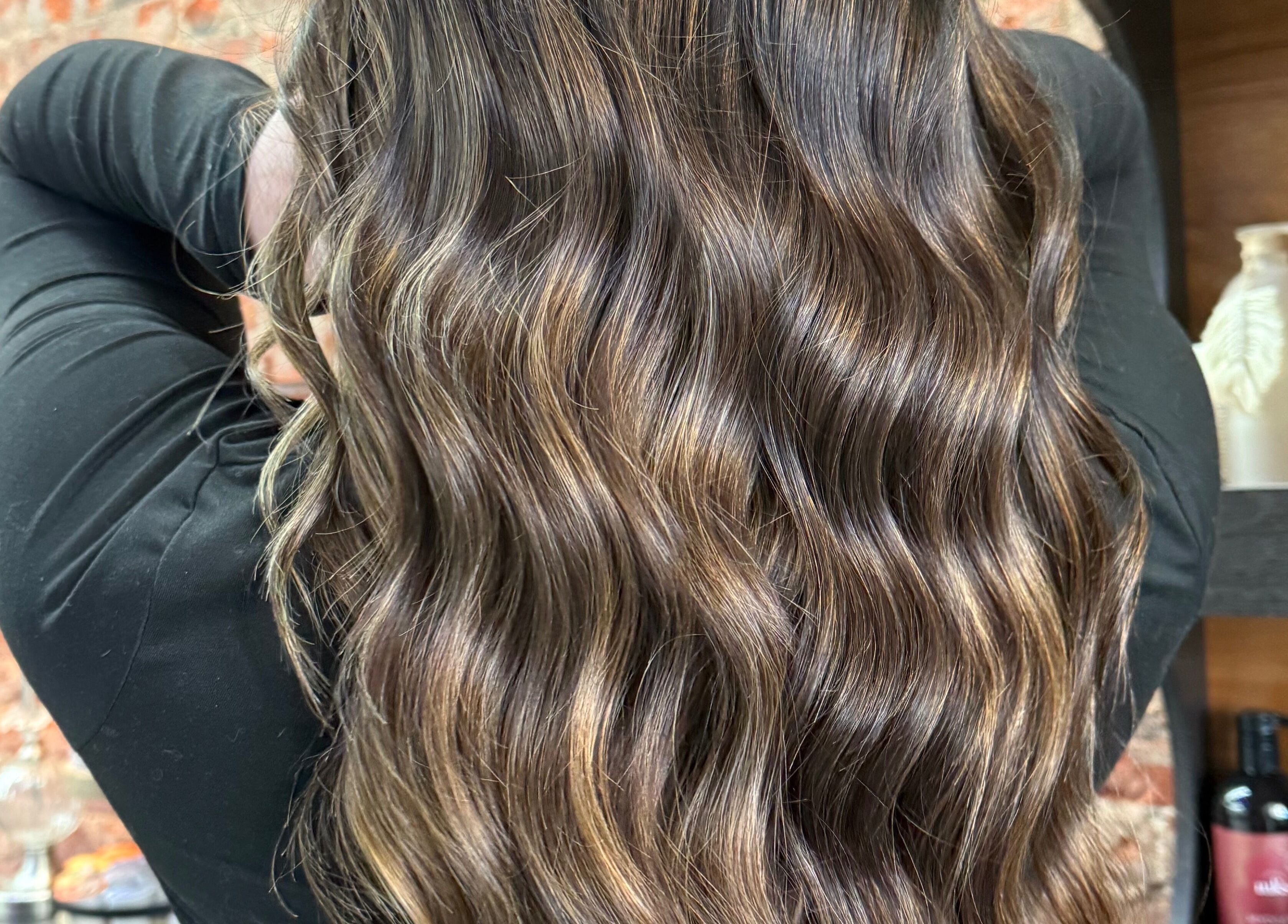 Shiny wavy hairstyle at Emmah at Transcendence Salon & Spa, Columbus, Nebraska, US.