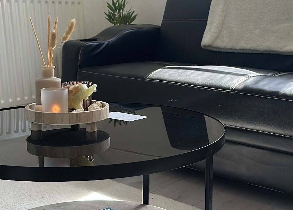 Serene lounge area at BBH SKIN, Brent Pelham, England, GB with candles and a plush sofa.