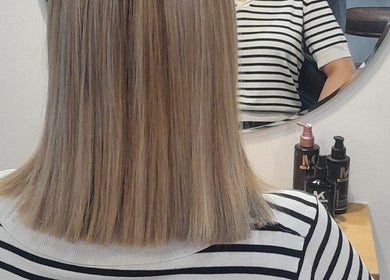 Straight hair styled at HAIR BY LILI, Pretoria, Gauteng, ZA, reflected in mirror with styling products visible.