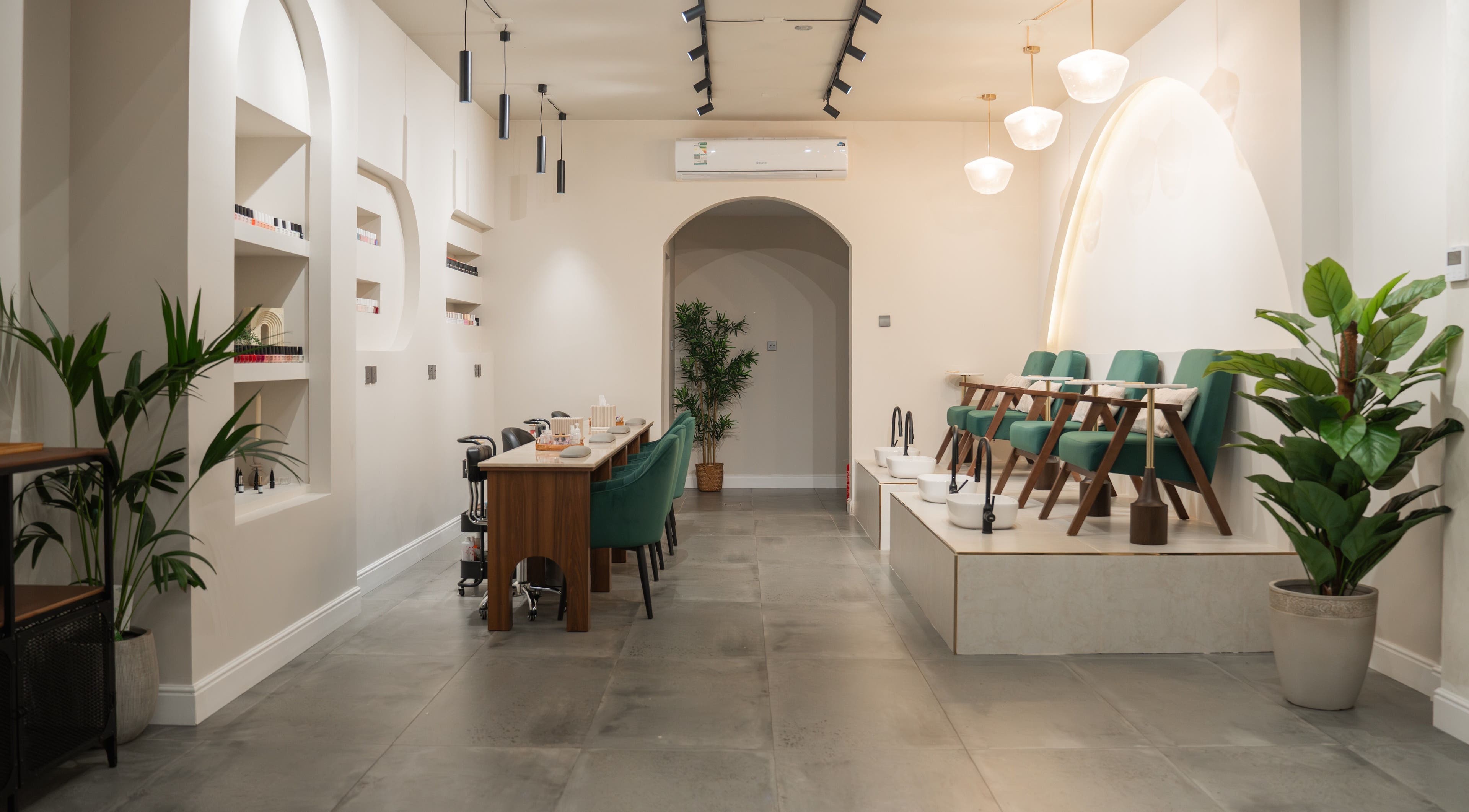 Elegant interior of Arches Beauty Center, Tarut, Eastern Province, SA showcasing modern design and green accents.