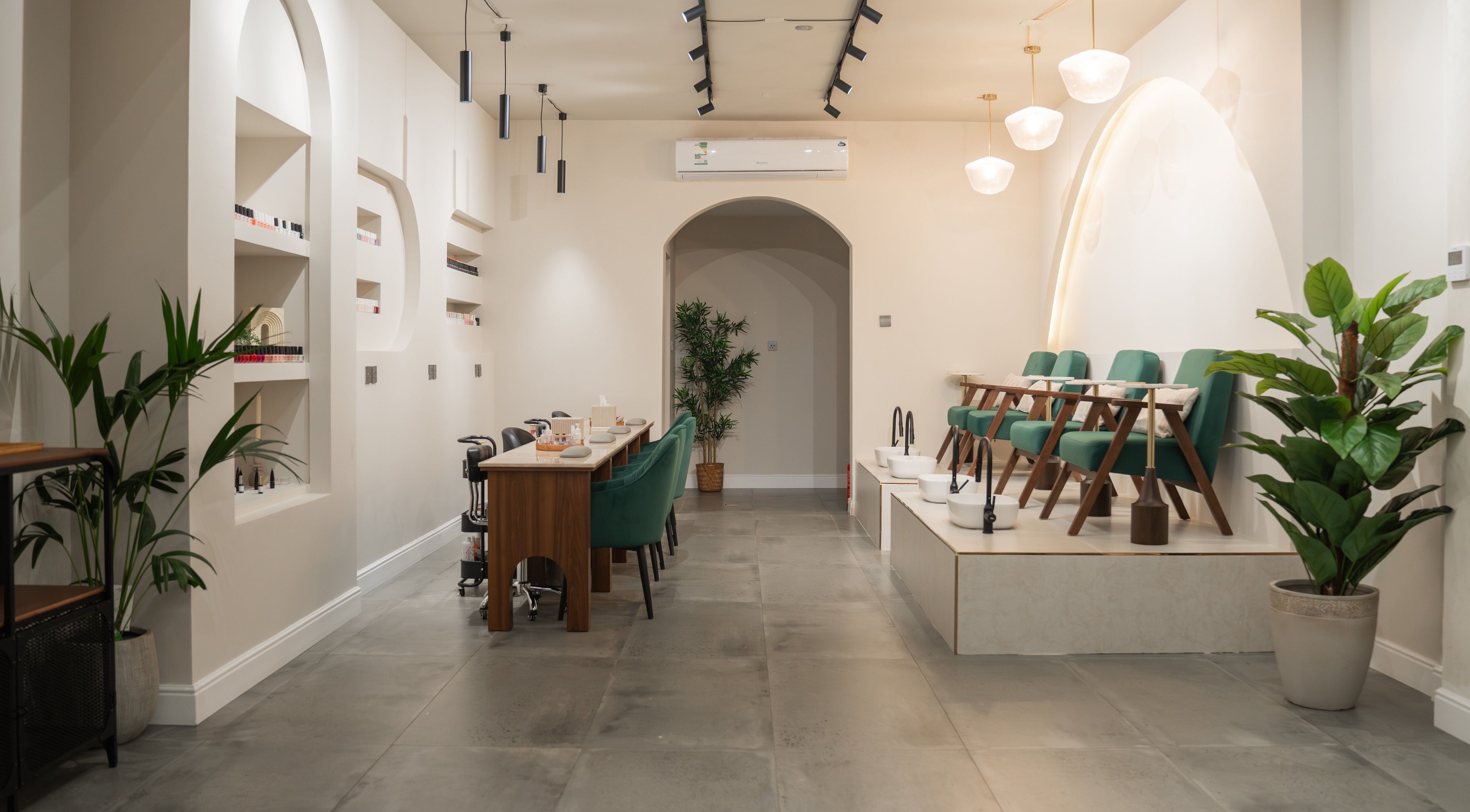 Elegant interior of Arches Beauty Center, Tarut, Eastern Province, SA showcasing modern design and green accents.