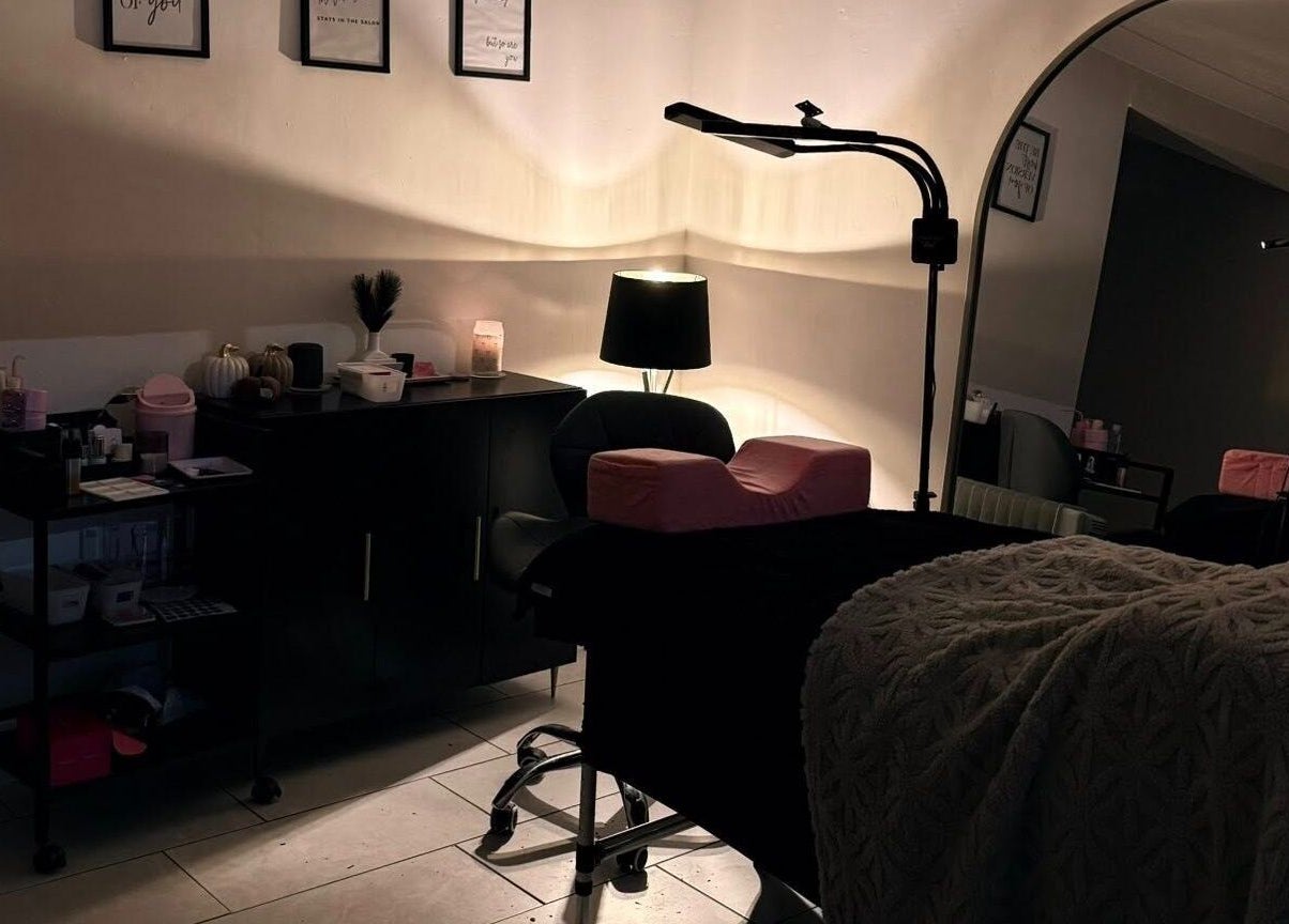Elegant beauty room at Caits Cosmetics, Whittlesey, England, GB featuring plush treatment bed and warm lighting.