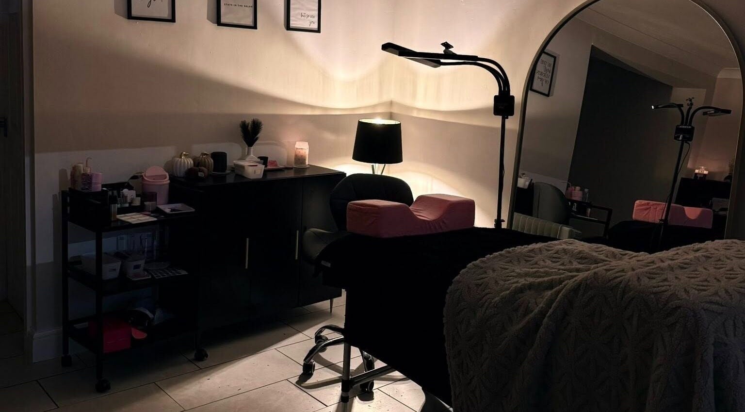 Elegant beauty room at Caits Cosmetics, Whittlesey, England, GB featuring plush treatment bed and warm lighting.