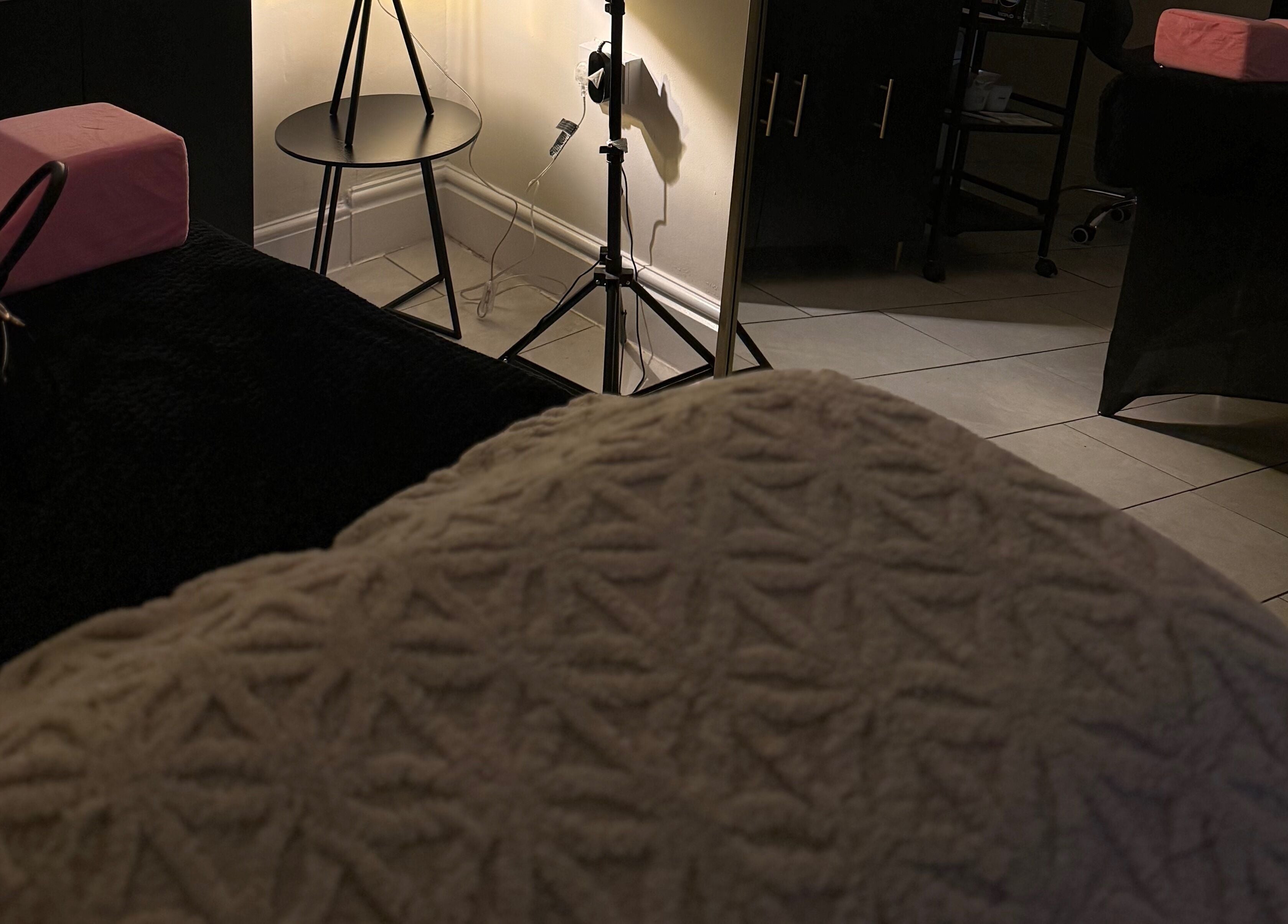 Relaxing treatment room at Caits Cosmetics, Whittlesey, England, GB with soft lighting and comfortable decor.