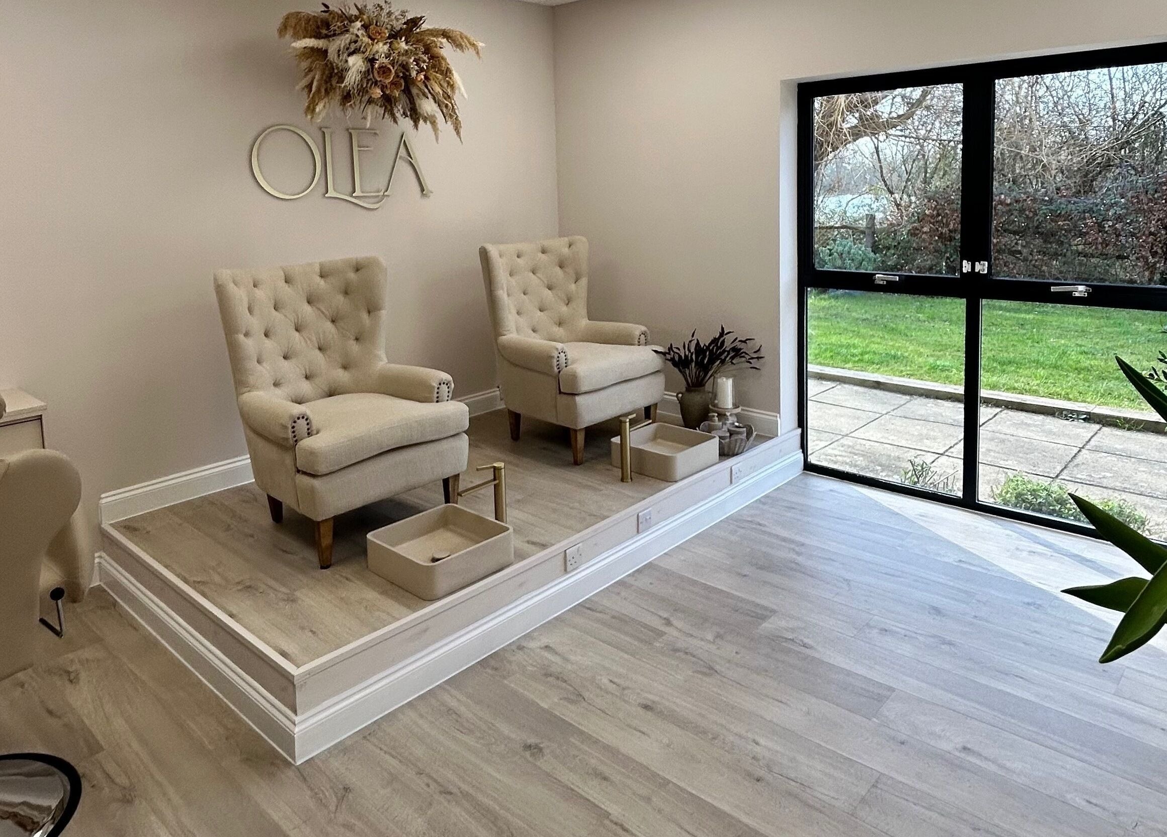 Chic pedicure area in Olea The Room of Beauty, Hemingford Grey, England, GB, with plush chairs and natural light.