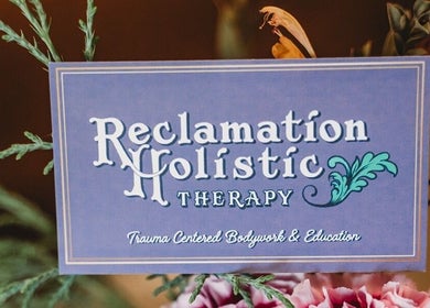 Reclamation Holistic sign in Buffalo, New York, US, at Phoenix Rising Wellness Collective amidst floral decor.