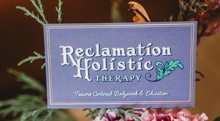 Reclamation Holistic sign in Buffalo, New York, US, at Phoenix Rising Wellness Collective amidst floral decor.