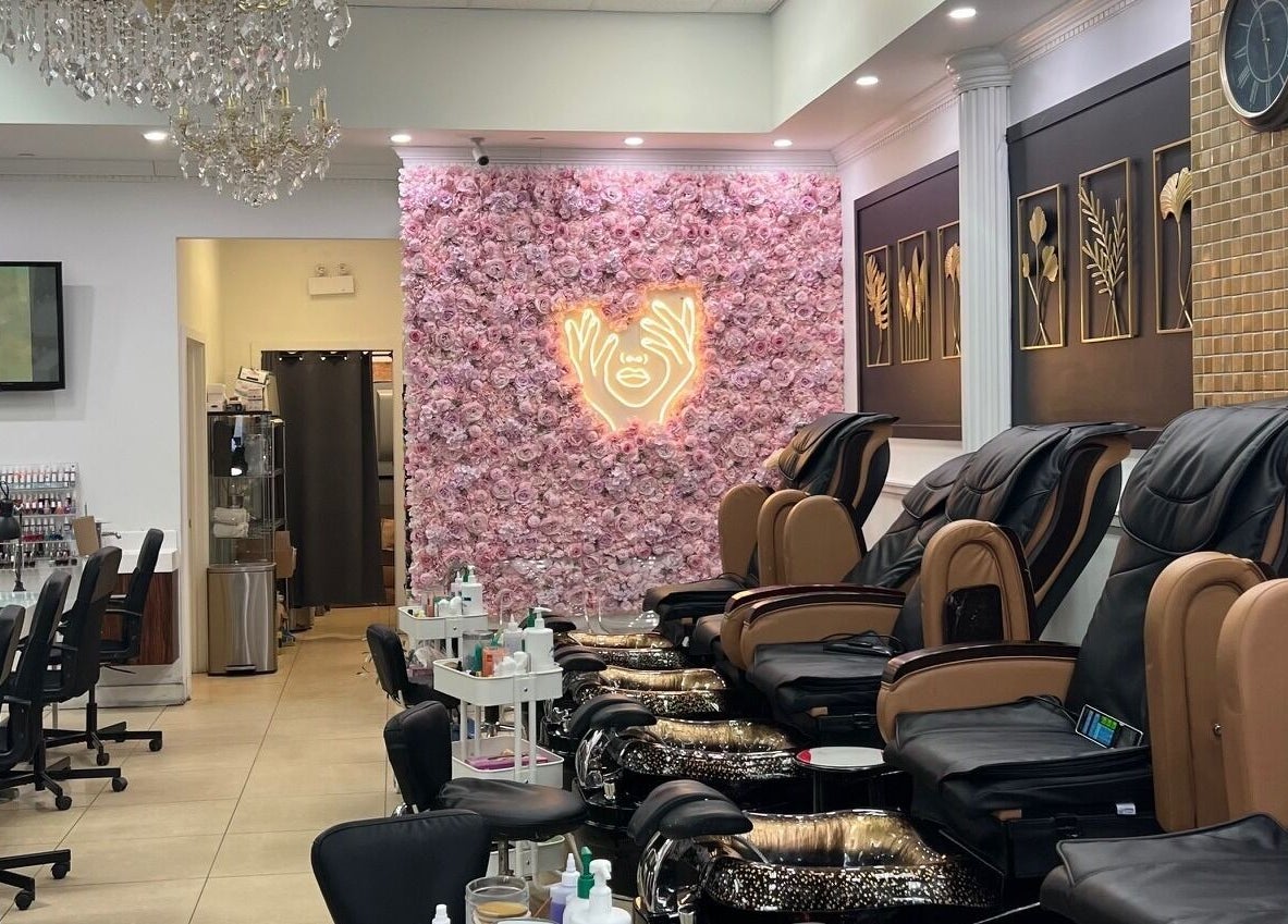 Modern nail salon interior at Nails For You Dundas, Toronto, Ontario, CA, featuring plush pedicure chairs and floral wall.