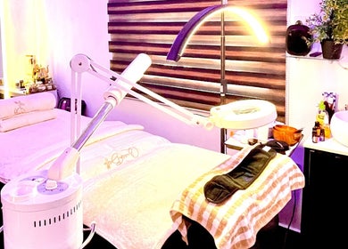 Relaxing spa room at Queen Bello Services, Lagos, NG with massage table and ambient lighting.