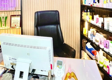 Reception area at Queen Bello Services, Lagos, Lagos, NG, showcasing beauty products on display shelves.