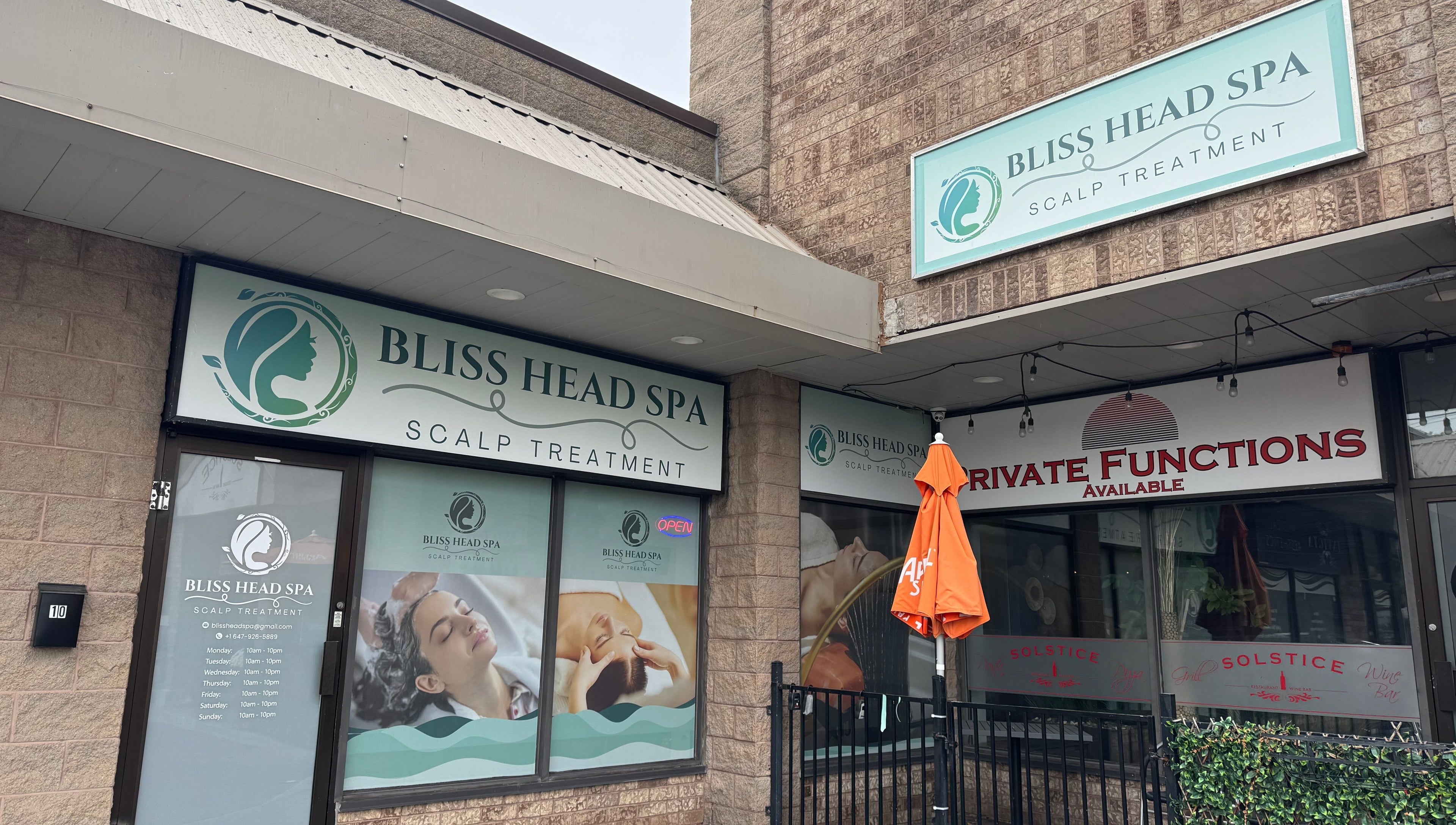 Entrance of Bliss Head Spa in Mississauga, Ontario, CA, showcasing scalp treatment signage.