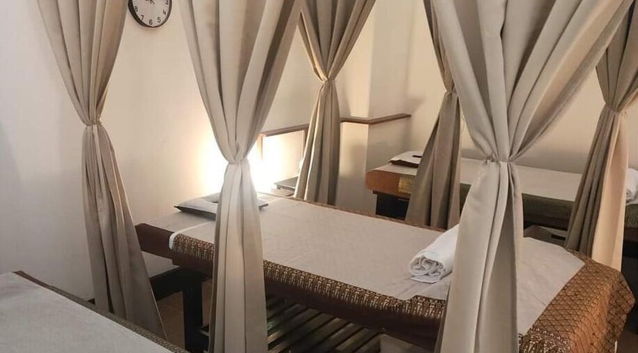 Tranquil massage beds at Arncliffe Thai Massage in Arncliffe, New South Wales, AU with elegant curtains.