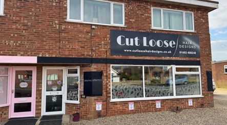 Exterior of Cut Loose Hair Designs in Norwich, England, GB with stylish storefront and signage.