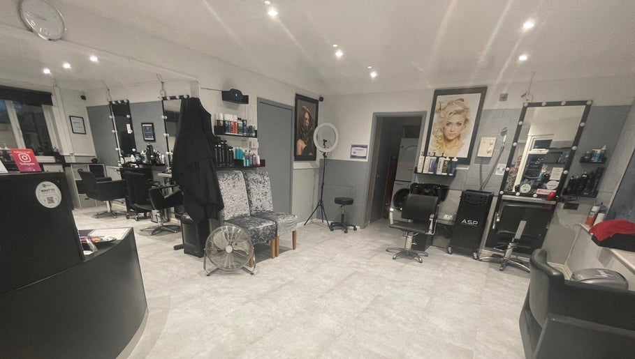 Interior of Cut Loose Hair Designs in Norwich, England, GB, featuring stylish hair stations and modern decor.
