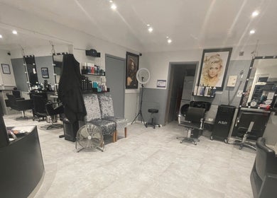 Interior of Cut Loose Hair Designs in Norwich, England, GB, featuring stylish hair stations and modern decor.