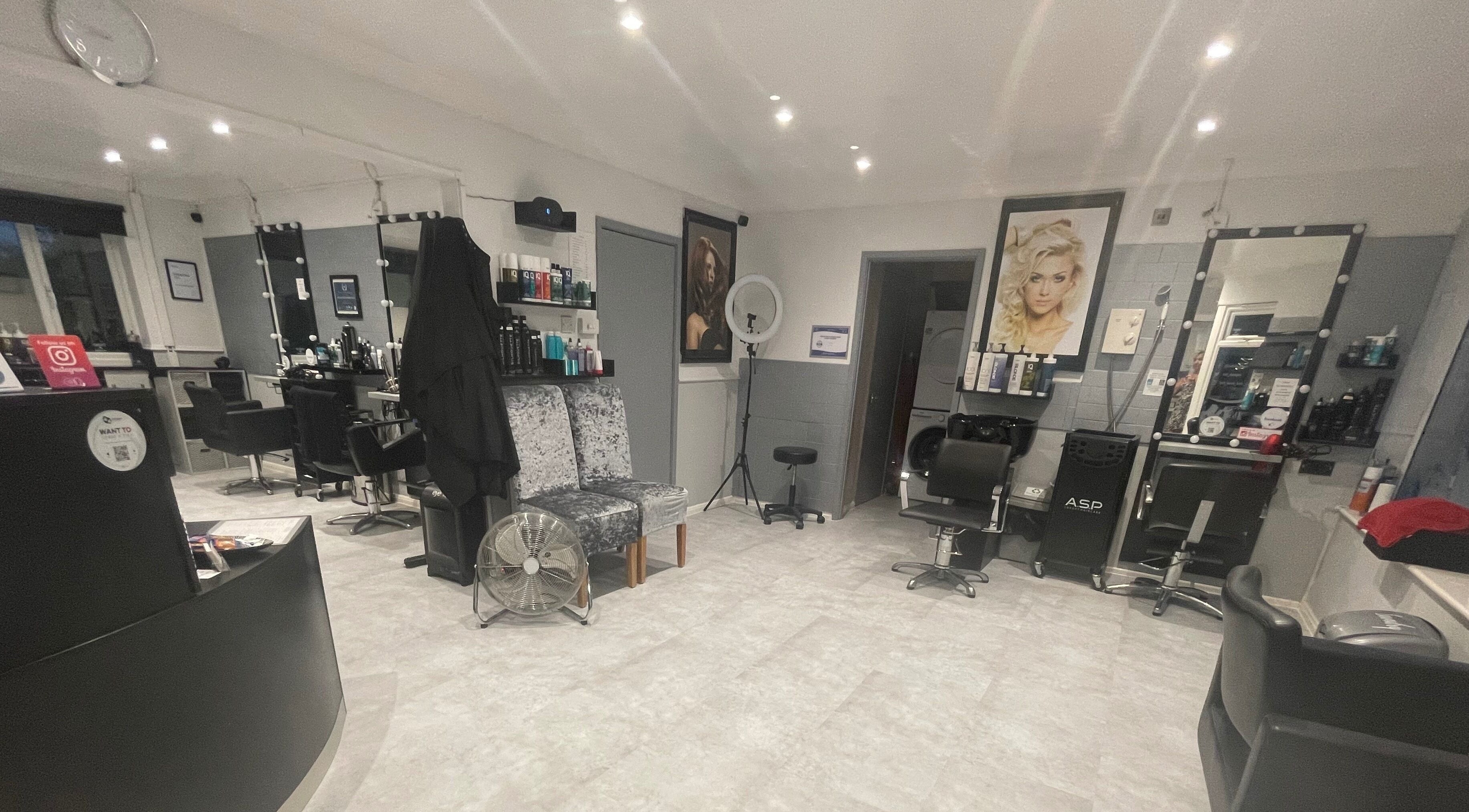 Interior of Cut Loose Hair Designs in Norwich, England, GB, featuring stylish hair stations and modern decor.