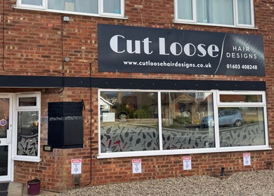 Exterior of Cut Loose Hair Designs in Norwich, England, featuring stylish signage.