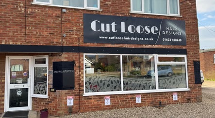 Exterior of Cut Loose Hair Designs in Norwich, England, featuring stylish signage.