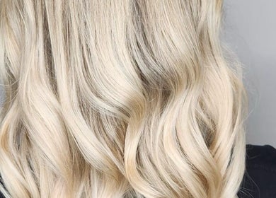 Blonde wavy hairstyle at Cut Loose Hair Designs, Norwich, England, GB showcasing elegant hair craftsmanship.