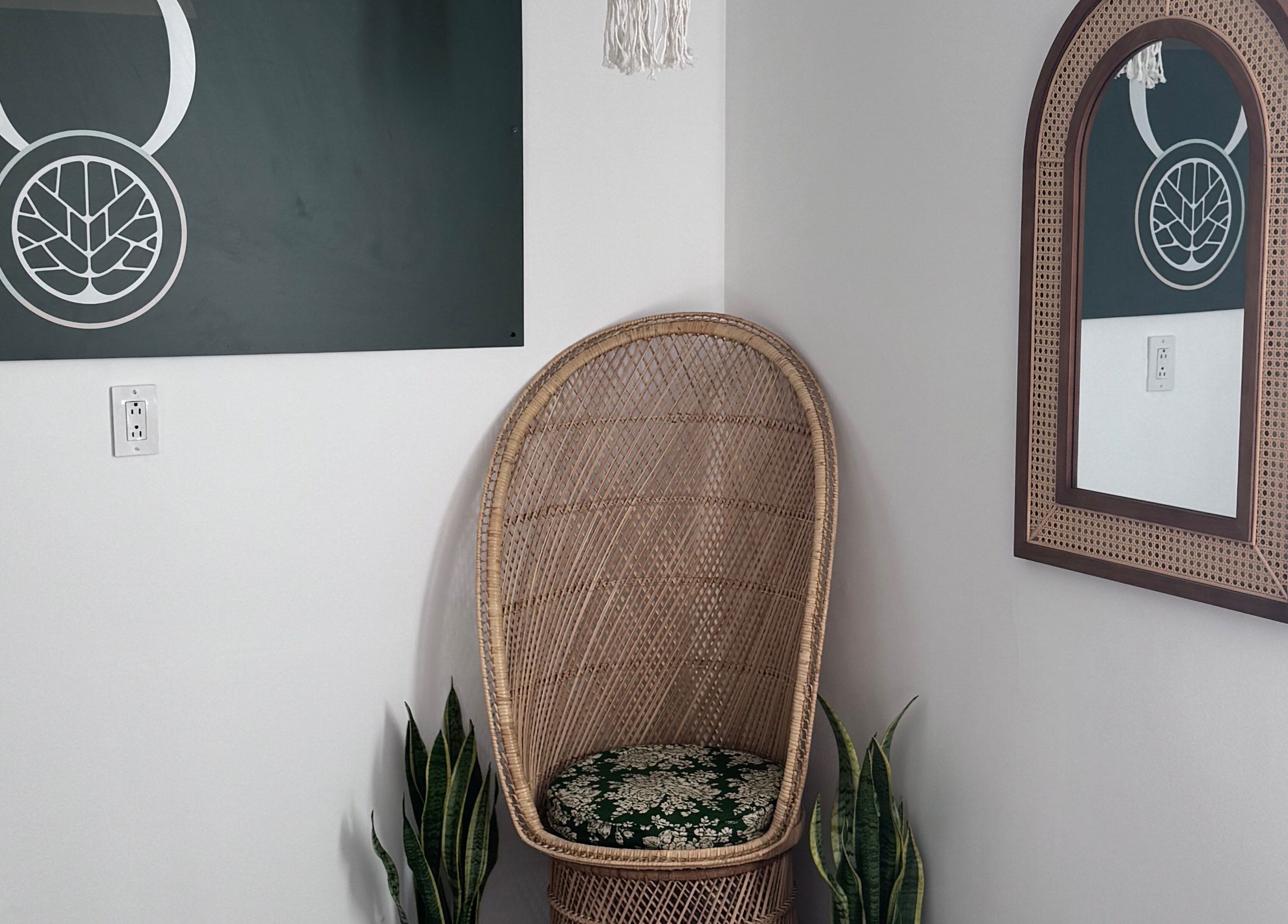 Peaceful corner at Bien-être Boho NDG, Montréal, Québec, CA features wicker chair and mirror.