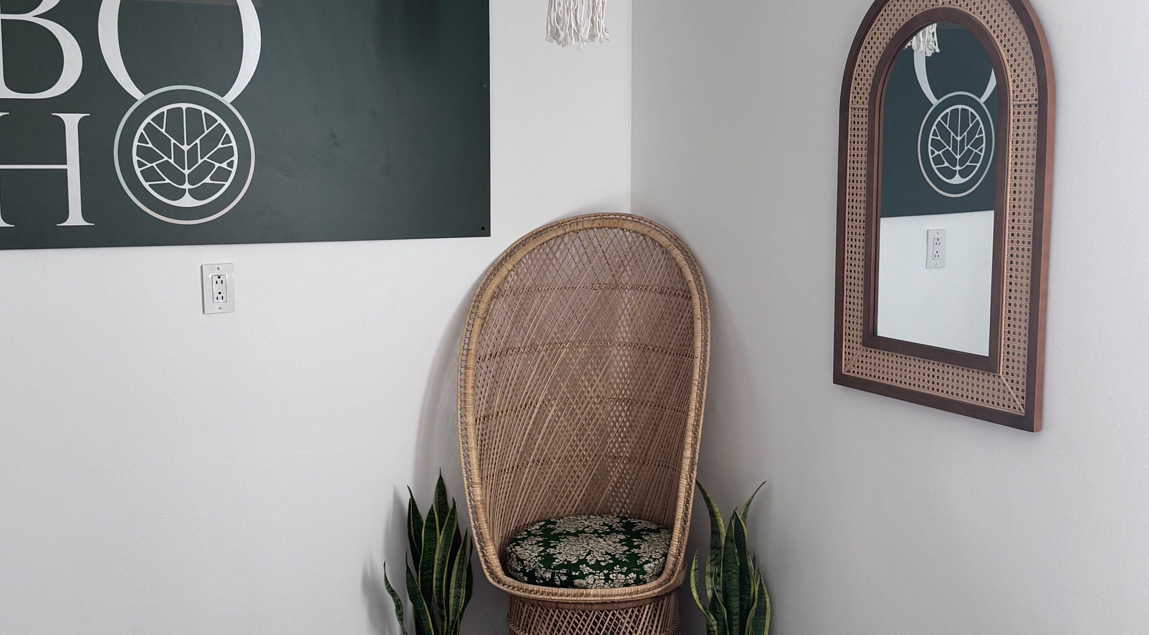 Peaceful corner at Bien-être Boho NDG, Montréal, Québec, CA features wicker chair and mirror.