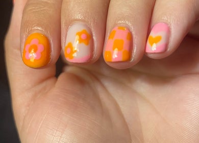 Vibrant floral nail art at Nails by Emily, Camberley, England, GB. Showcasing orange and pink designs.