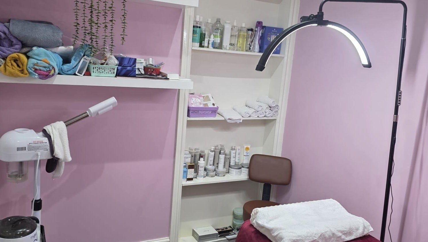 Relaxing treatment room at Twinz Beauty (Ladies only), Tamworth, England featuring products and decor.