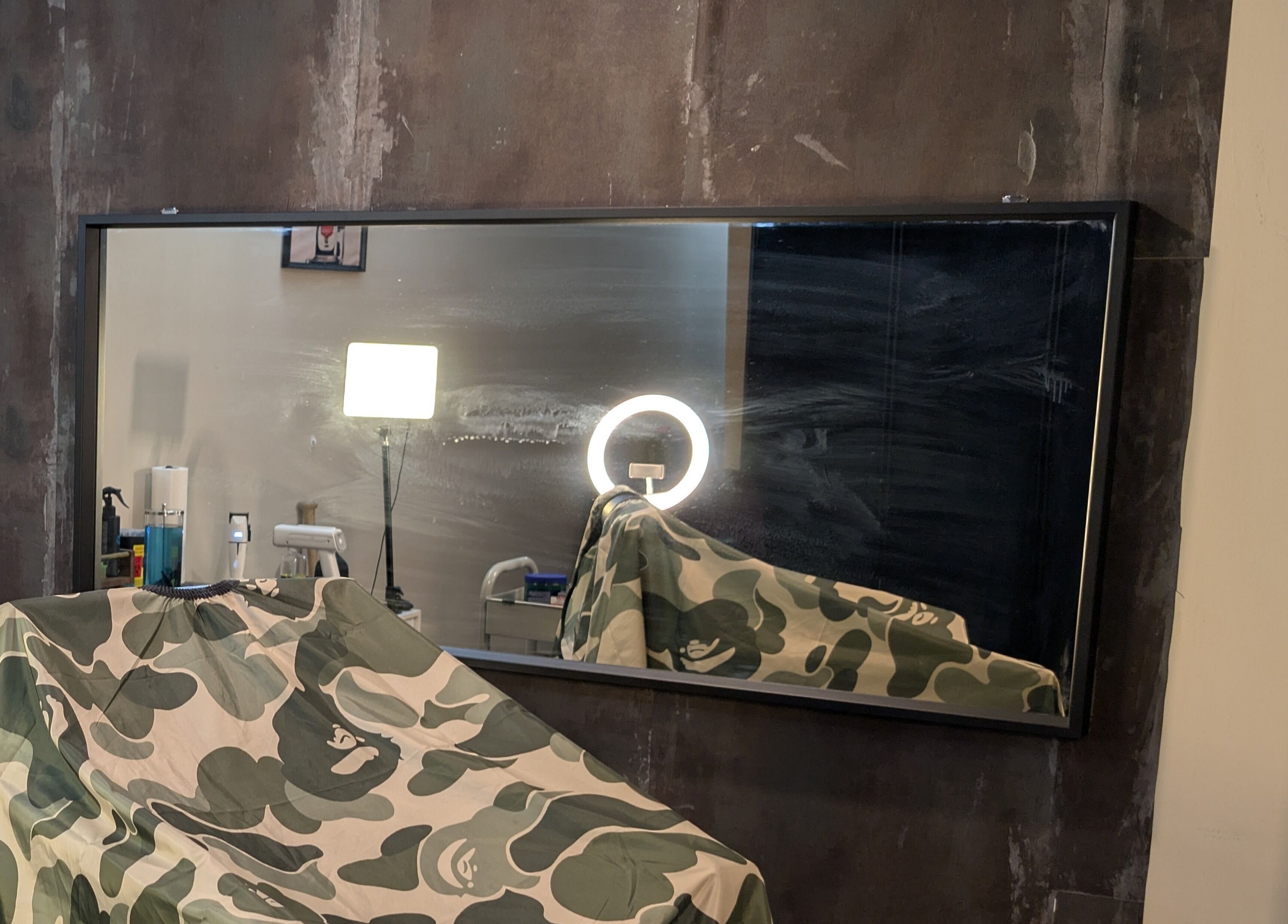 Modern salon interior at T.Cutzzz, Pickering, Ontario, CA with mirrored wall and equipment.