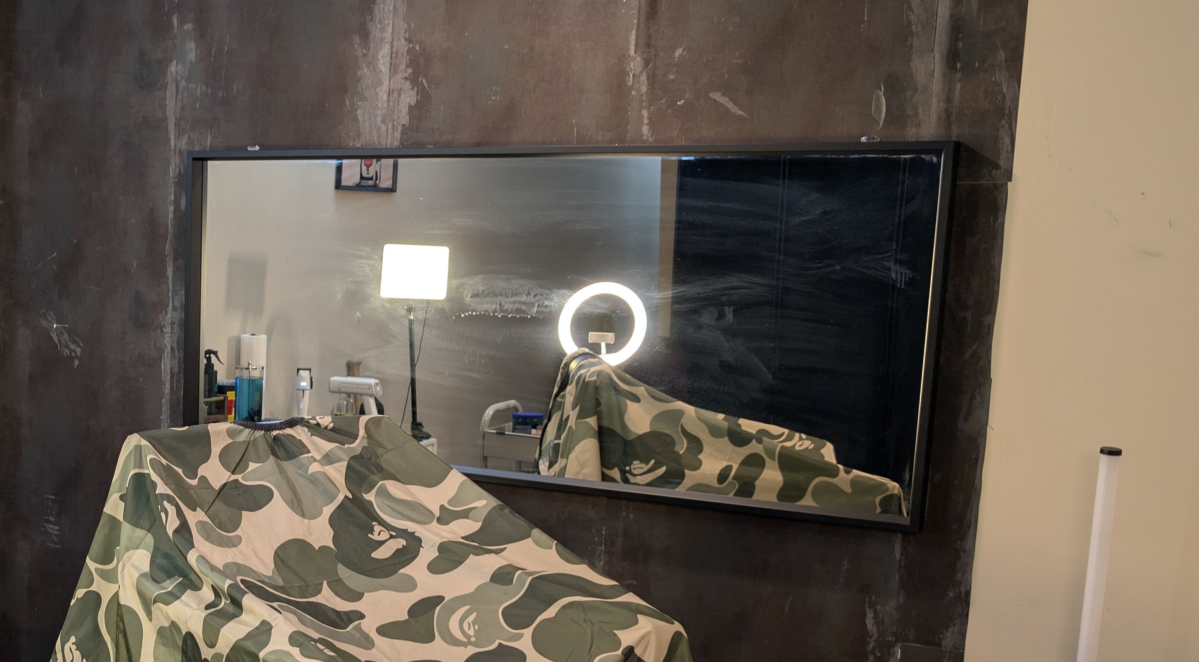 Modern salon interior at T.Cutzzz, Pickering, Ontario, CA with mirrored wall and equipment.