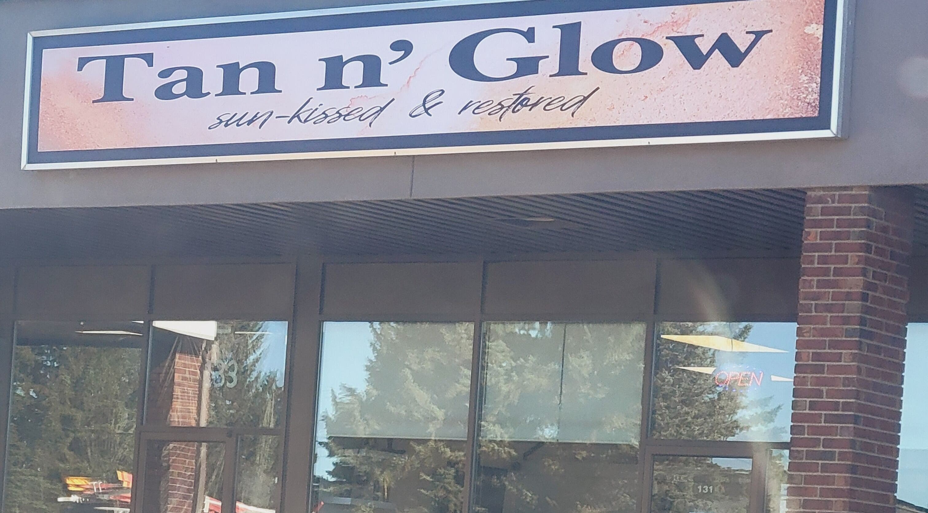 Entrance of Tan n'Glow in Medicine Hat, Alberta, CA showcasing stylish signage.