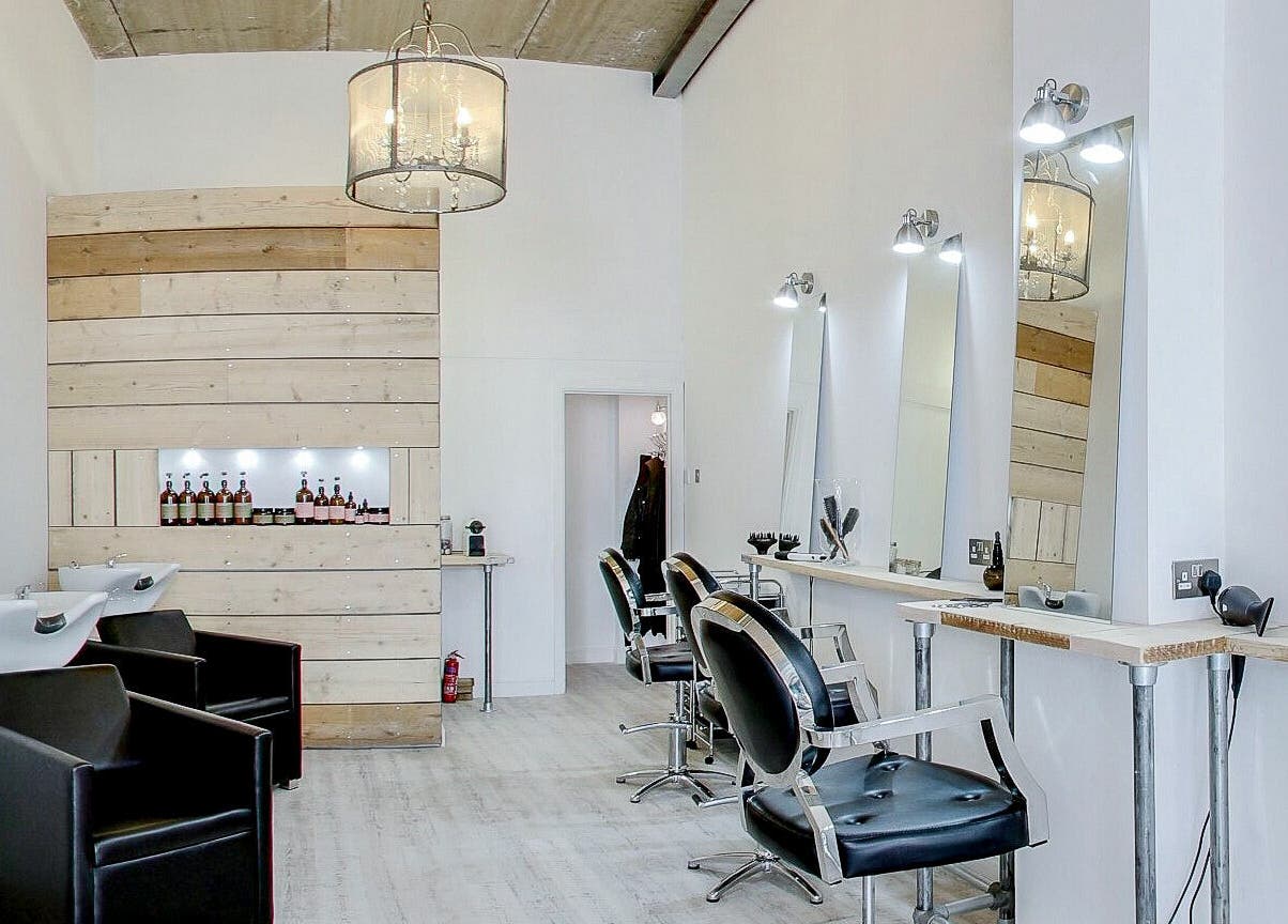 Elegant salon interior at The Styling Rooms, Rugby, England, GB. Features modern chairs and illuminated mirrors.