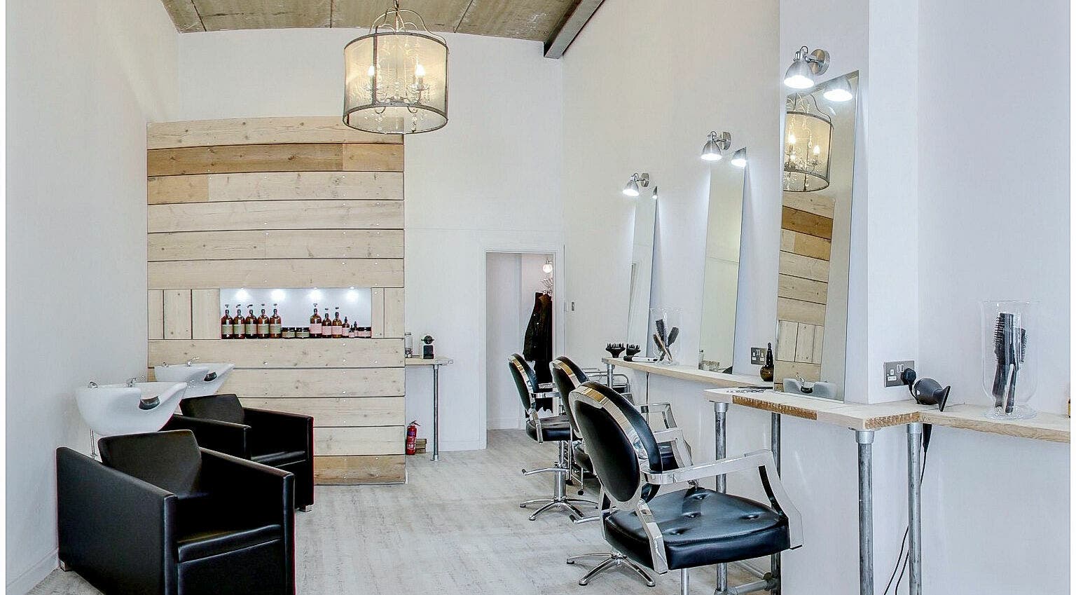 Elegant salon interior at The Styling Rooms, Rugby, England, GB. Features modern chairs and illuminated mirrors.