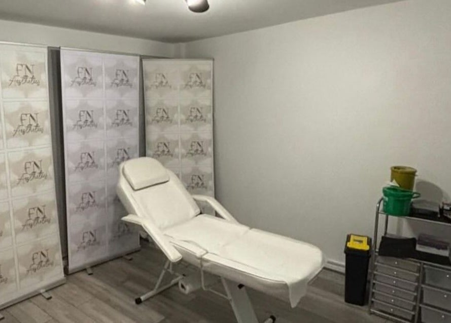 Relaxing treatment room at FN Aesthetics in Denham, England, GB showcasing a reclined spa chair.